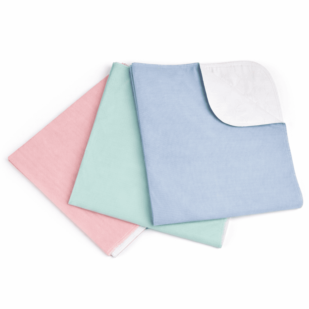 Reusable Under pads 34 x 52 inch folded in pink, green and blue.