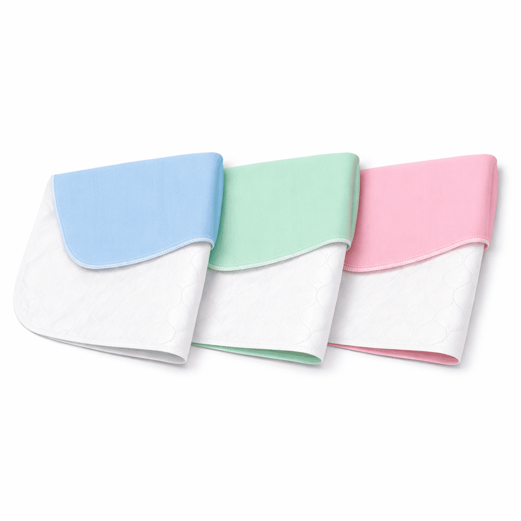 Reusable Under pads 34 x 36-inch folded blue, green and pink.