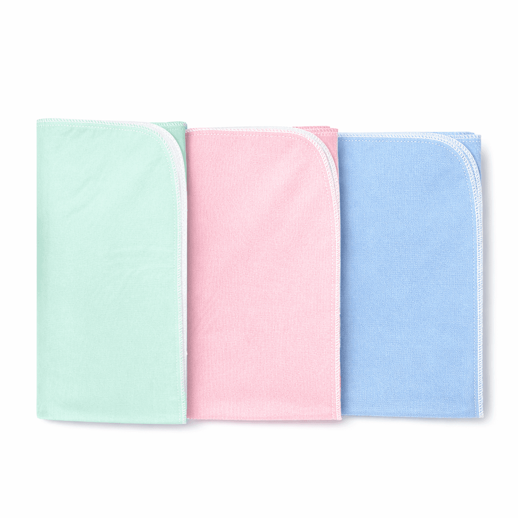 Reusable Under pads 34 x 45 inch folded in green, pink and blue.