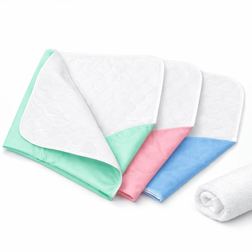 Reusable Under pads 30 x 36 inch folded in green, pink and blue.