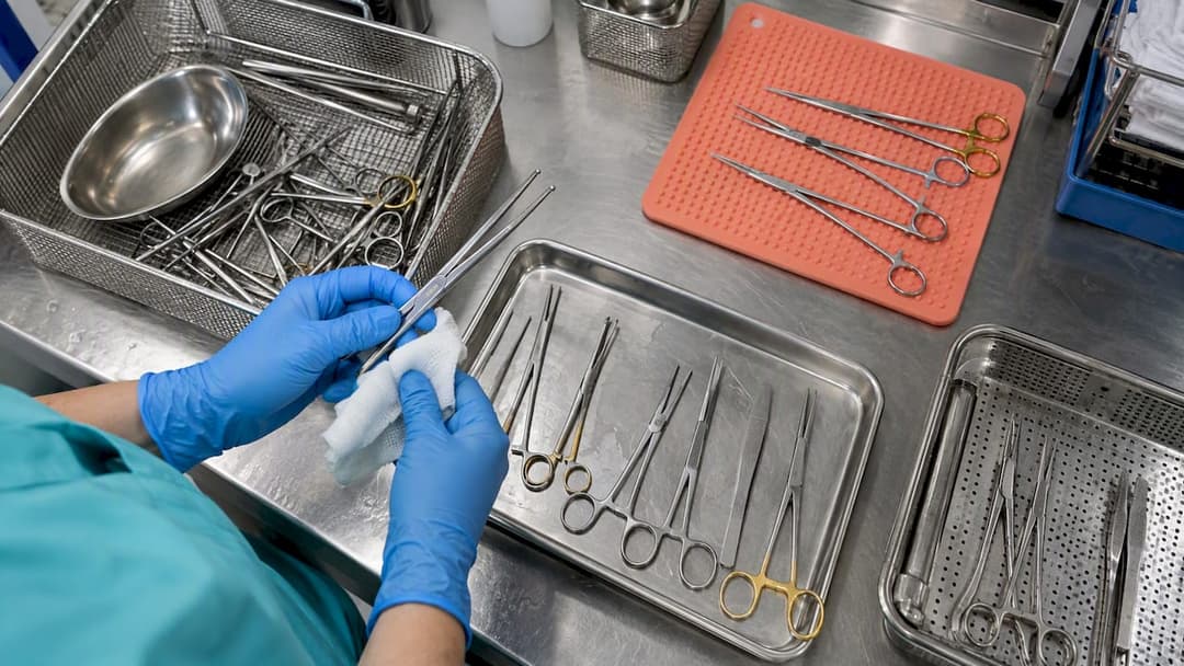 Assorted surgical forceps on an inspection bench