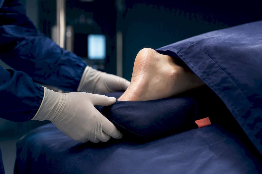 Clinician adjusting patient positioning support