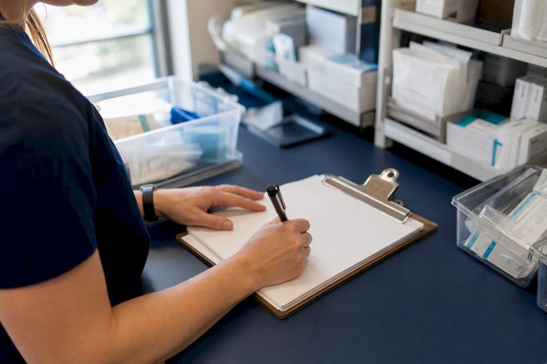 Hands filling medical supply account form